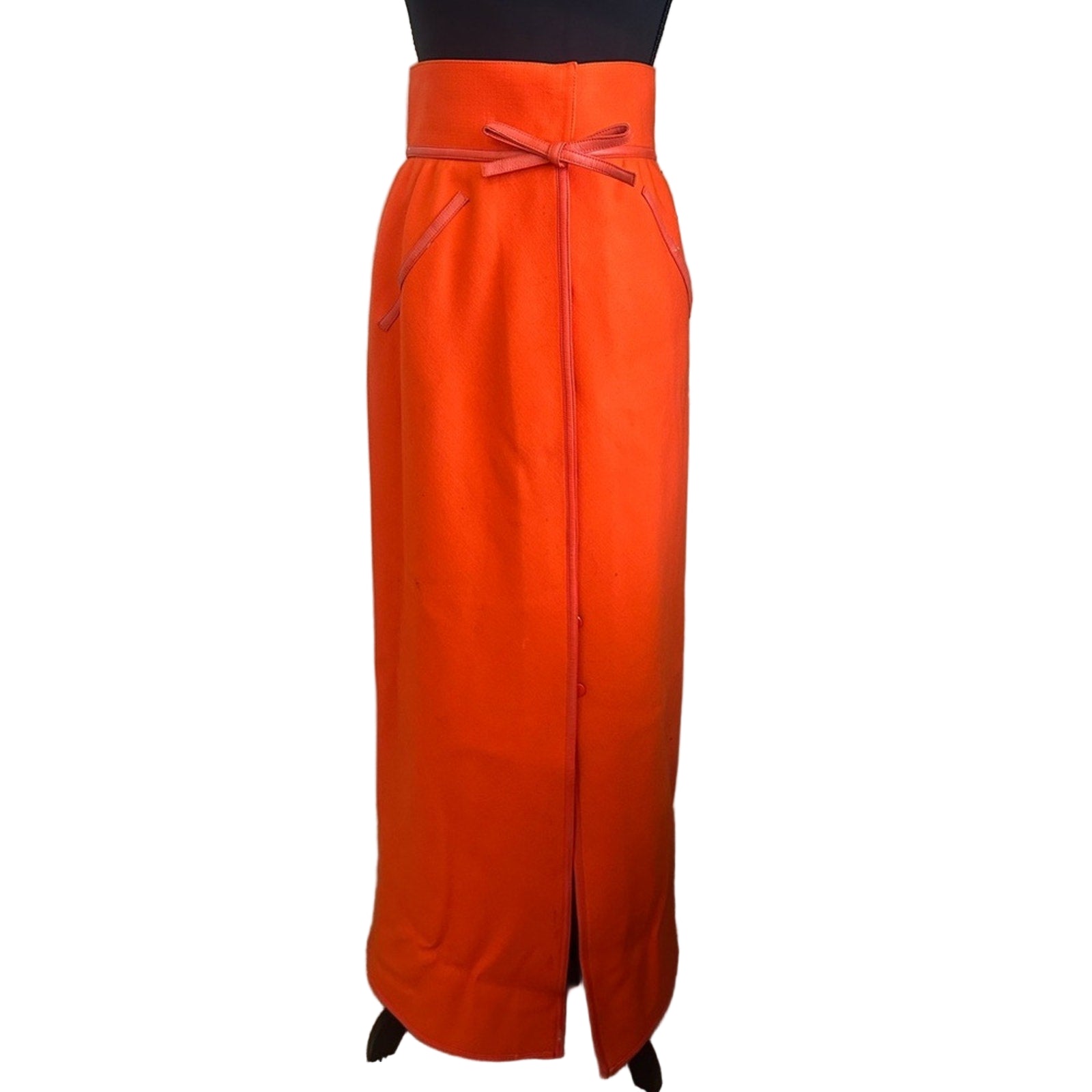Orange skirt with a belt on a plain background